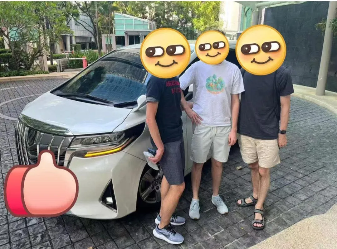 Customers posing with a white Toyota Alphard chauffeur van