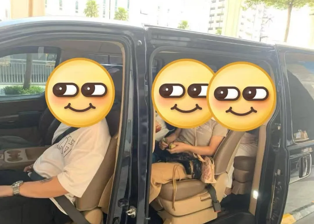 Customers seated inside a black MPV with the doors open