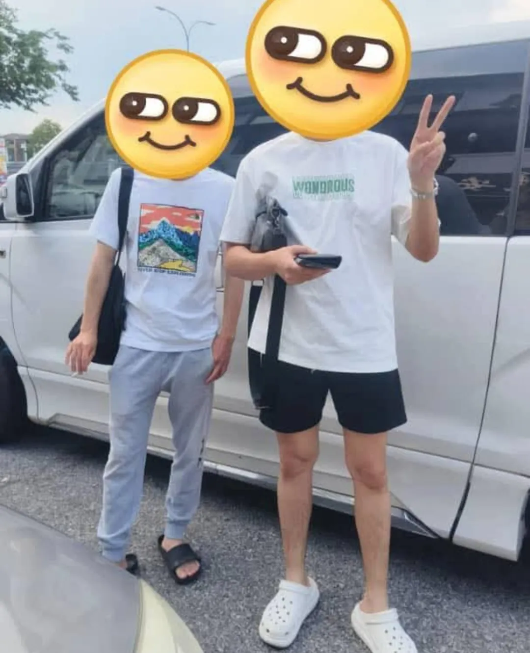 Two customers posing beside a white van