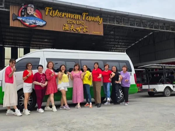 A group of customers with their chauffeur van outside Fisherman Family restaurant in Malaysia