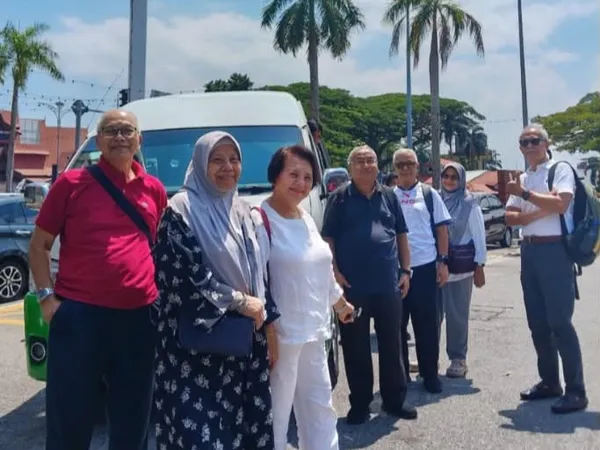 A group of elderly travellers with their chauffeur van in Malaysia