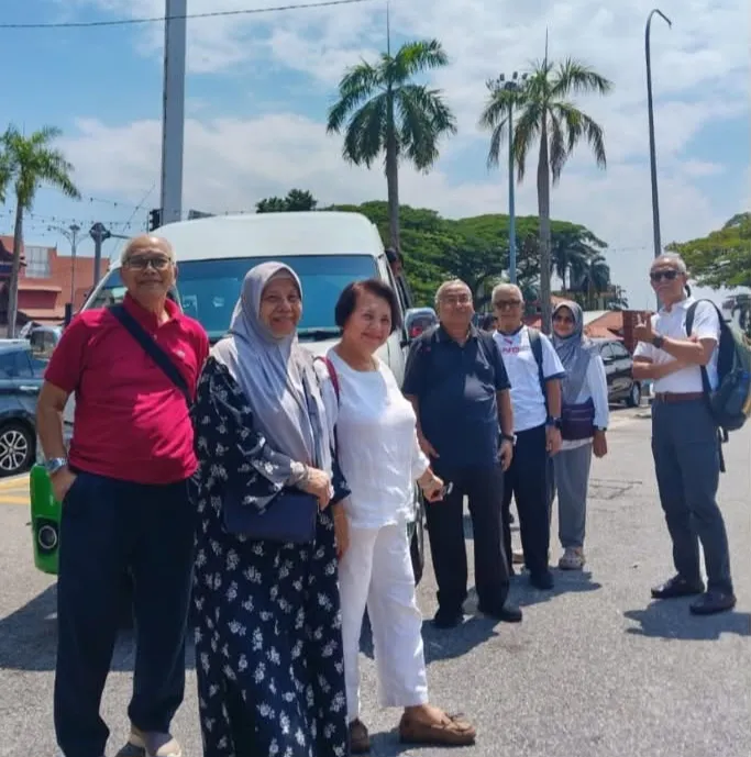 A group of elderly travellers with their chauffeur van in Malaysia